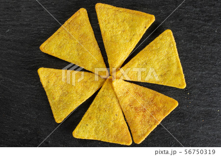 Tortilla cheese chips on grey stone Tortilla cheese chips on grey stone 56750319