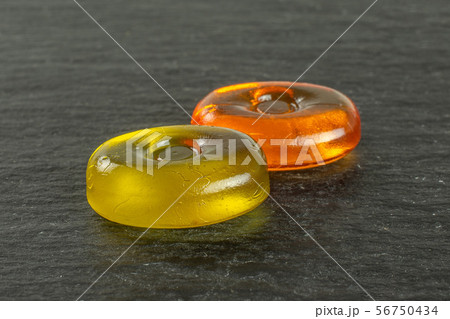 Colourful hard candy on grey stone Colourful hard candy on grey stone 56750434
