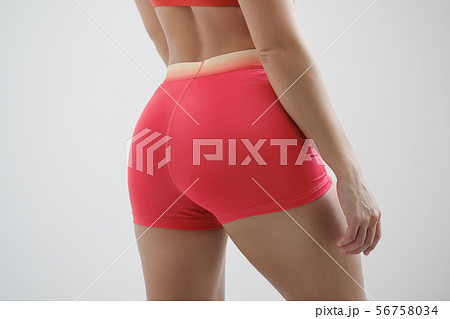 Booty girl in a red sportswear on a light background. Booty girl in a red sportswear on a light background. 56758034
