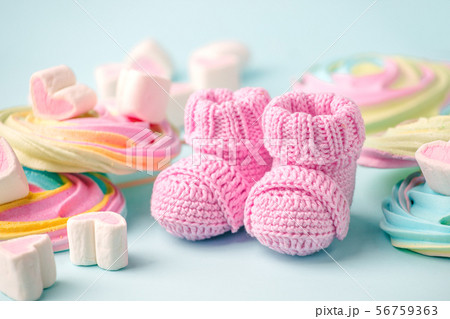 pair of small baby socks on blue background with 56759363