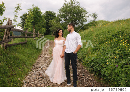 Lovestory of beautiful couple in the mountains, Handsome bearded man with beautiful and charming 56759692