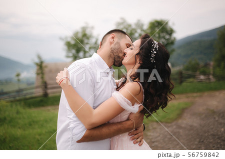 Beautiful wedding couple in Carpathian mountains. Handsome man with attractive woman. Bride spin Beautiful wedding couple in Carpathian mountains. Handsome man with attractive woman. Bride spin 56759842