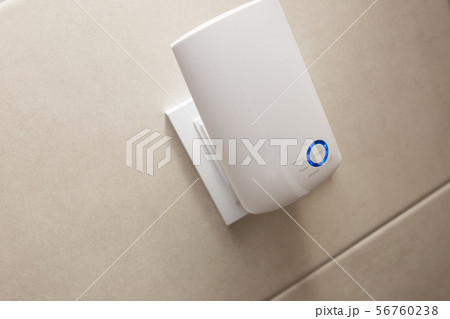Wifi home repeater plugged in closeup. Wifi home repeater plugged in closeup. 56760238
