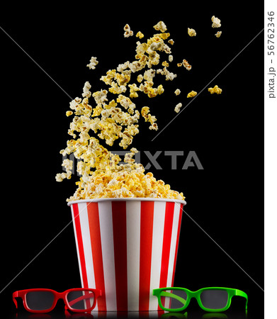 Paper striped bucket with popcorn and glasses isolated on black background 56762346