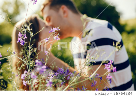 Beautiful couple spend time on a summer field 56764234