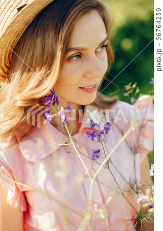 Elegant and stylish girl in a summer field Elegant and stylish girl in a summer field 56764259