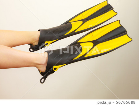 Woman presenting flippers female legs in fins Woman presenting flippers female legs in fins 56765689
