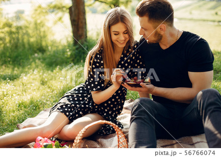 Beautiful couple spend time in a summer field Beautiful couple spend time in a summer field 56766074