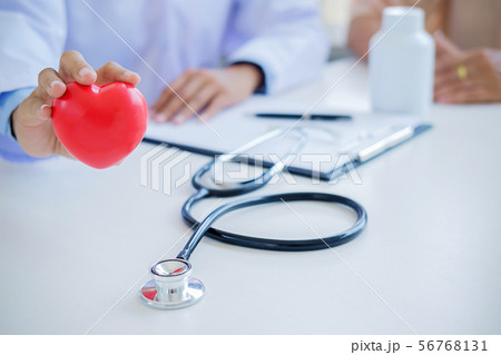 Doctor with stethoscope holding heart. Doctor and 56768131
