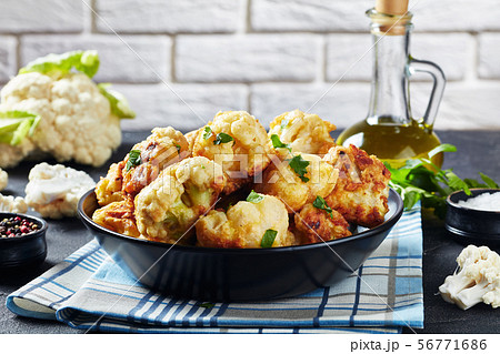 Cauliflower florets fried in batter, top view Cauliflower florets fried in batter, top view 56771686