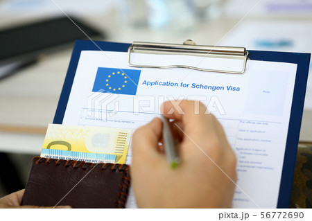 Male hand hold silver pen with passport Male hand hold silver pen with passport 56772690