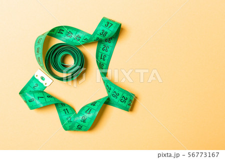 Top view of measure tape curtailed into a spiral Top view of measure tape curtailed into a spiral 56773167
