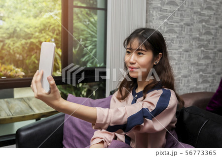 Asian businesswoman taking selfie photo. Asian businesswoman taking selfie photo. 56773365