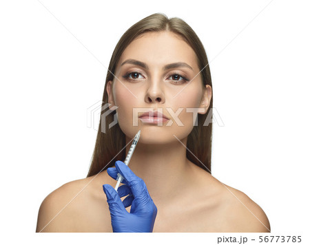 Portrait of beautiful young woman isolated on white studio background 56773785