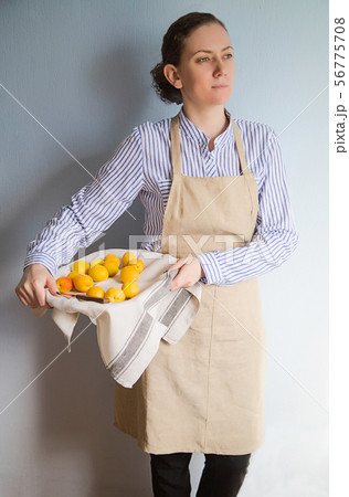 Young woman with a tray of peaches and apricots 56775708