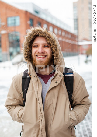 A bearded young man walks on winter street A bearded young man walks on winter street 56775743