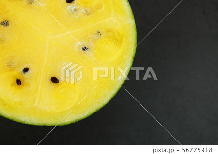 Half of tasty and ripe yellow watermelon on a Half of tasty and ripe yellow watermelon on a 56775918