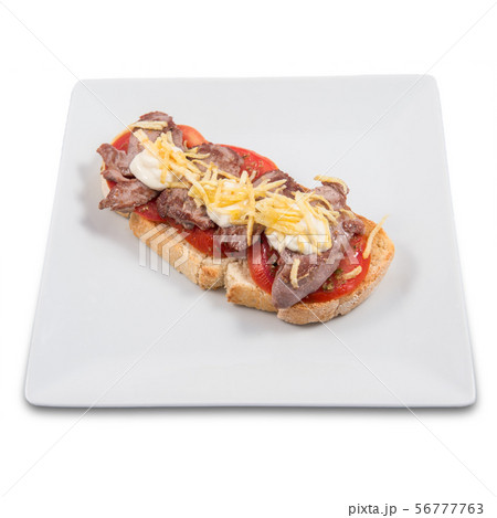 Toast of Iberian pork sirloin on a natural tomato base Toast of Iberian pork sirloin on a natural tomato base 56777763
