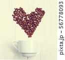 Grain of coffee in the form of a heart over a cup. 56778093