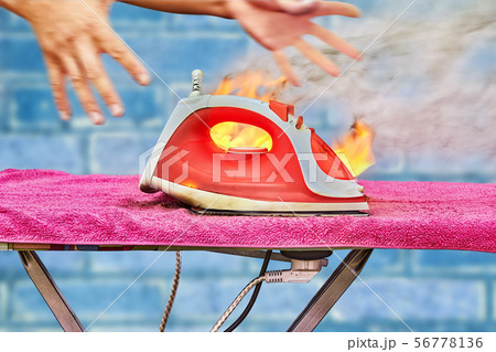 The iron for clothes is overheated and ignited. The iron for clothes is overheated and ignited. 56778136