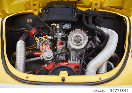 A small engine, an old cute car, in the back 56778345