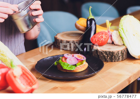 Chef making healthy vegetarian salmon burgers outdoor on open kitchen, odprta kuhna, international Chef making healthy vegetarian salmon burgers outdoor on open kitchen, odprta kuhna, international 56778477