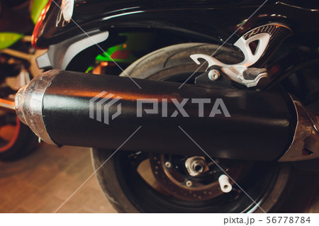 rear view of classical motorcycle pair of exhaust chrome pipes selective focus. 56778784