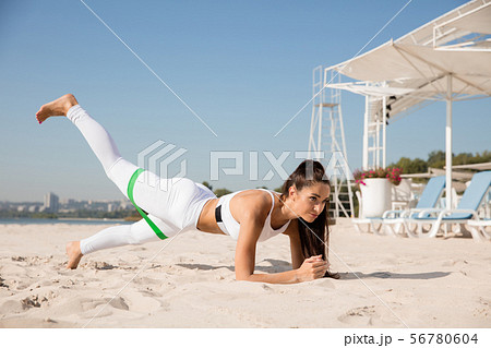 Young healthy female athlete doing workout at the beach 56780604