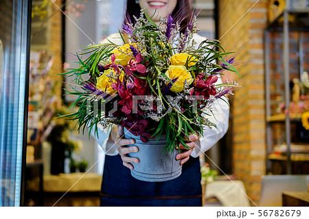 Cheerful charming young business owner flower shop Cheerful charming young business owner flower shop 56782679