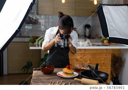 photographer food , asian women is taking pictures 56783901