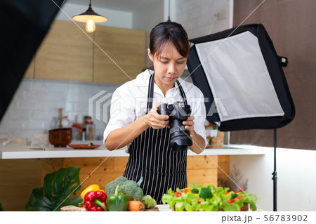 photographer food , asian women is taking pictures 56783902