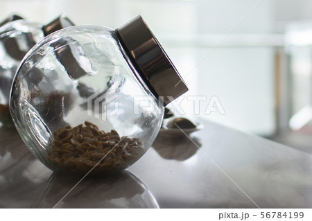 Peanuts in glass jars, soft light tones 56784199