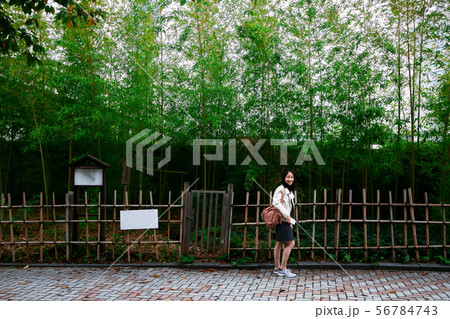 Asian girl walking in Japanese bamboo garden Asian girl walking in Japanese bamboo garden 56784743