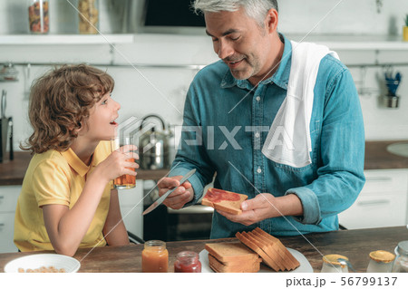 Happy father and little kid making breakfast Happy father and little kid making breakfast 56799137