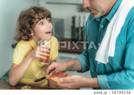Father with son making toast on breakfast 56799138