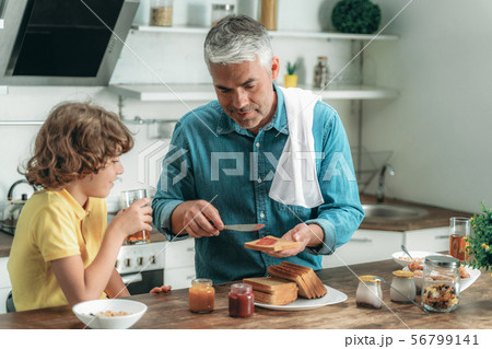 Happy father and little kid making breakfast 56799141