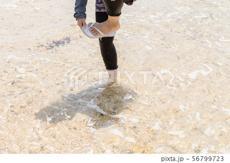 ビーチを歩く女性 56799723