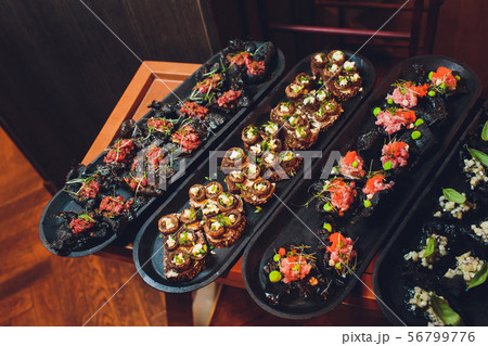 crackers with cream cheese and black caviar, horizontal. 56799776
