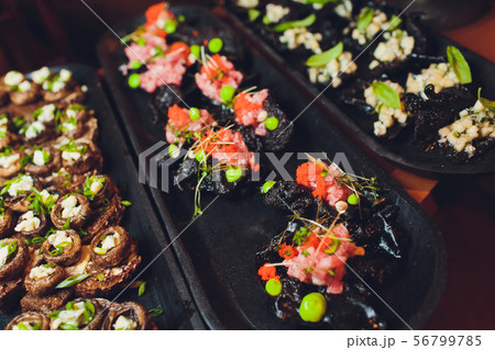 crackers with cream cheese and black caviar, horizontal. 56799785