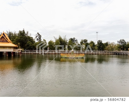 fountain in the middle of a pond in a Thai temple 56804782