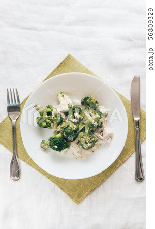 baked broccoli with chicken on a white plate. Top 56809329