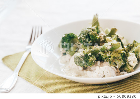 baked broccoli with chicken on a white plate. Top baked broccoli with chicken on a white plate. Top 56809330