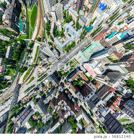 Aerial city view with crossroads and roads, houses, buildings, parks and parking lots. Sunny summer Aerial city view with crossroads and roads, houses, buildings, parks and parking lots. Sunny summer 56812140