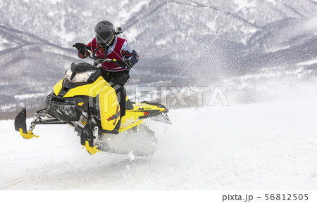 man is flying on a snowmobile on a background 56812505