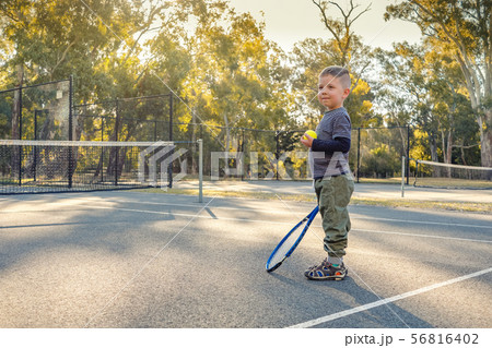 Little Australian boy playing tennis 56816402