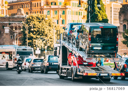 Auto-transport Carrying New Fiat Cars In European City Street. Auto Transport Broker Or Car Auto-transport Carrying New Fiat Cars In European City Street. Auto Transport Broker Or Car 56817069