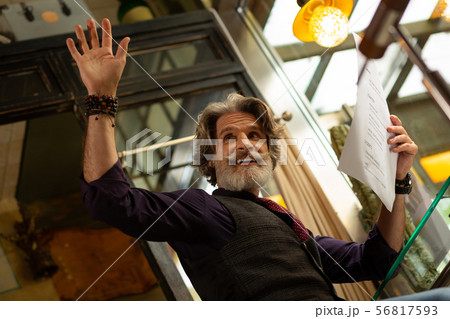 Cafe visitor calling a waiter before ordering coffee. 56817593