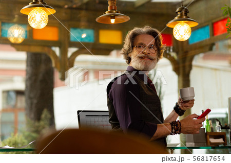 Smiling man turning back looking at waiter. Smiling man turning back looking at waiter. 56817654