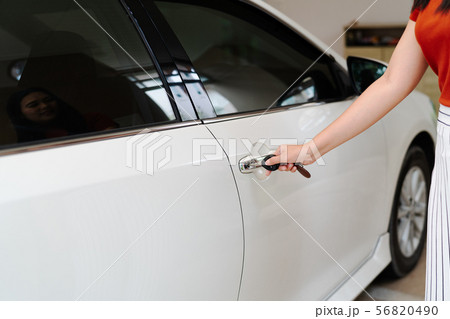 car unlocks, woman use key to open the car door 56820490
