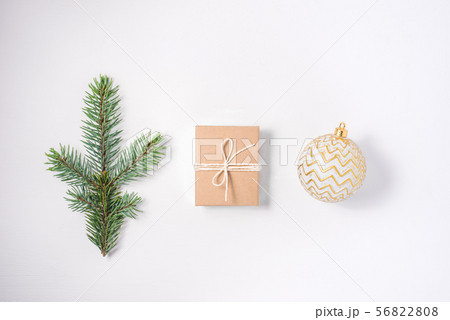 Christmas composition of a branch of fir, a gift and a silver ball. 56822808